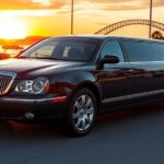 A glossy black limousine glides along a sunlit San Diego boulevard, its polished surface reflecting the iconic Coronado Bridge and a vibrant sunset over the bay, evoking luxury, reliability, and the promise of a stress‑free journey.