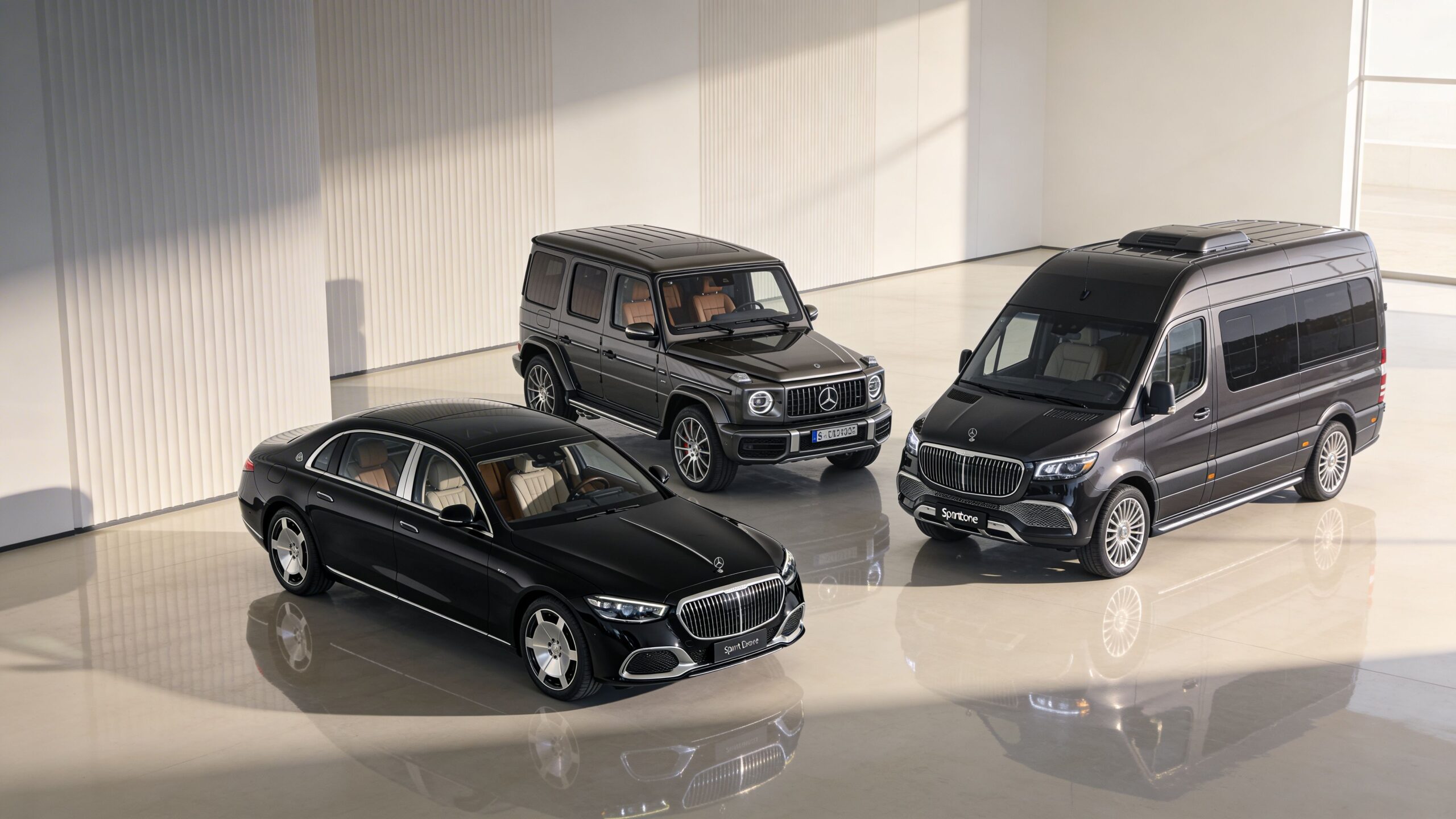 A professional private luxury Mercedes-Benz fleet including a sedan, G-Wagon, and a van in a studio.