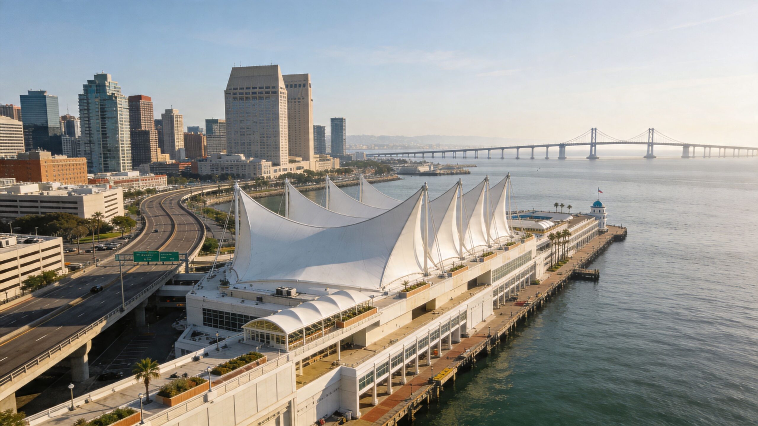 Transportation to San Diego Convention Center: A Guide 1 Rides On Time Aerial view of the San Diego Convention Center with its iconic white sails near the downtown skyline.